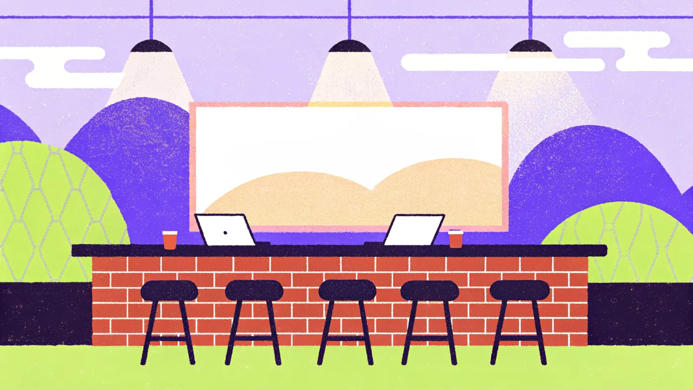 In Kapana zit de coworking letterlijk naast de bar Een coworkingruimte met bakstenen muren, laptops en een bar met tapkranen
